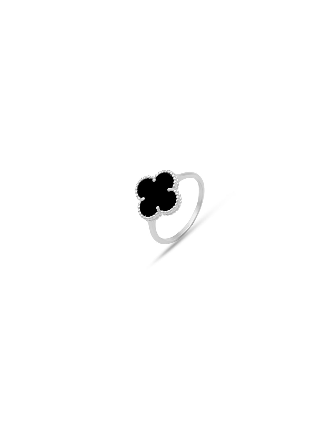 Silver ring with a black clover-shaped stone on a pink fabric background