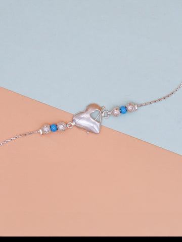 Elegant Silver Heart Rakhi with Blue & Silver Pearls