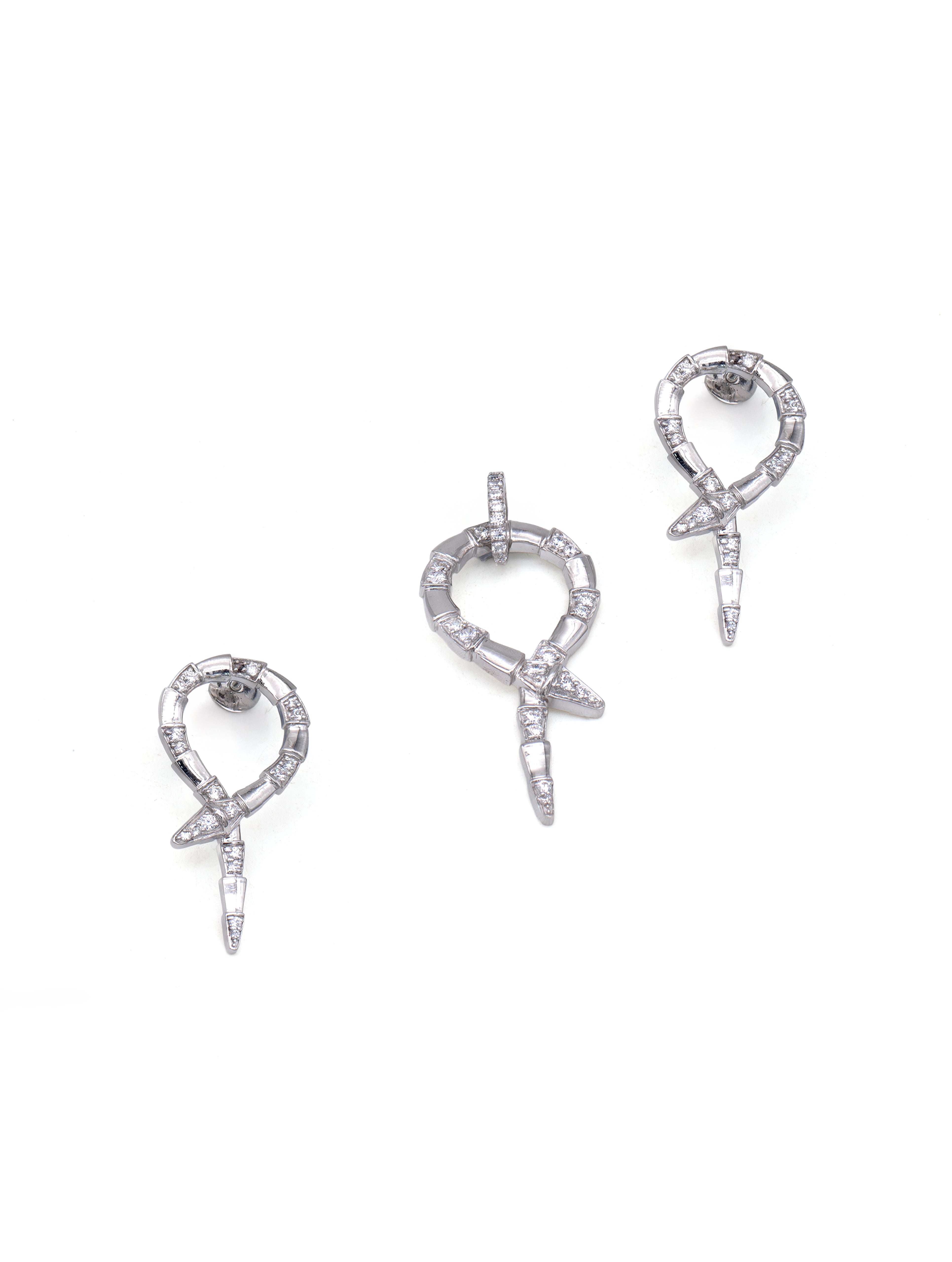 Pair of silver earrings with bow design on a white background