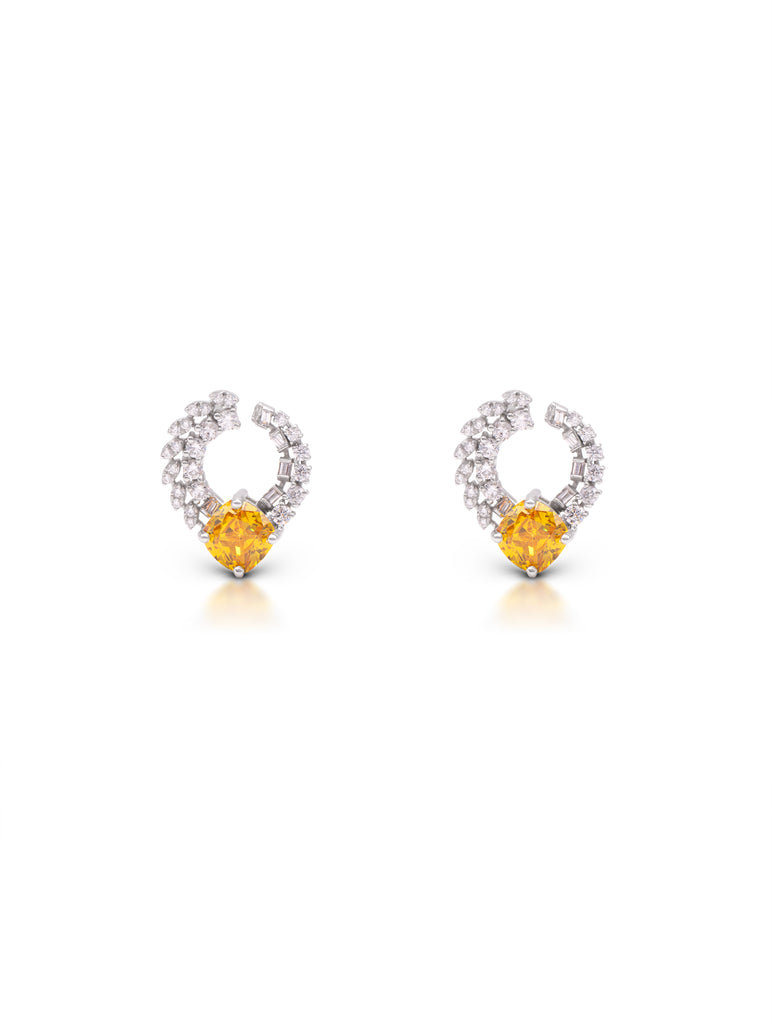 Pair of earrings with yellow gemstones and silver hoop designs on a white background
