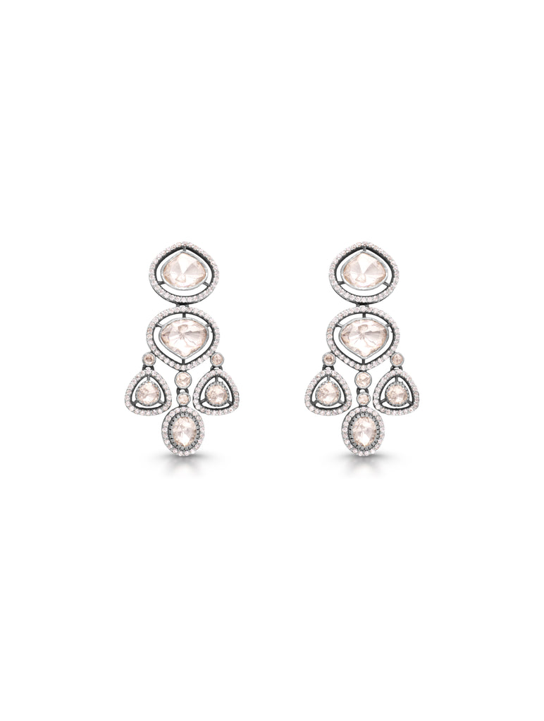 Pair of chandelier earrings with clear and pink gemstones on a white background