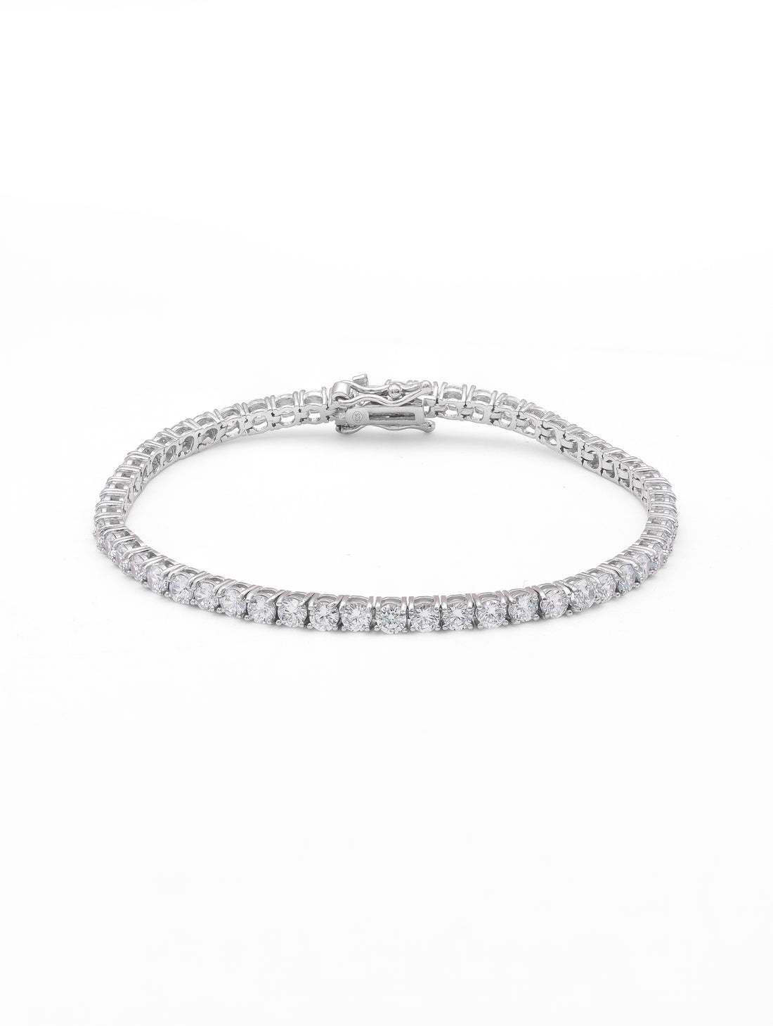 Silver bracelet with pink stones on a pink fabric background